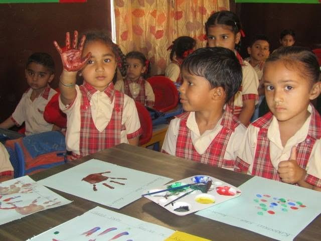 A child showing a painted hand