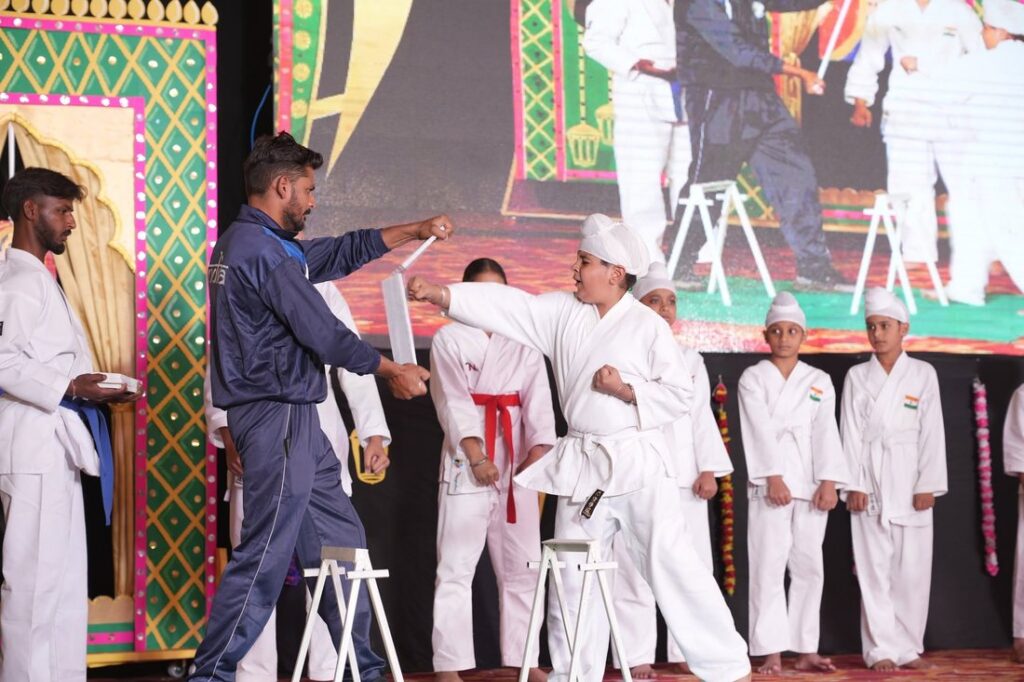 A pupil breaking a board at a karate demonstration